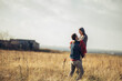 © Geber86 - Young couple having a stroll on a grassland in the countryside