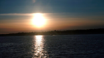 Poster - Dawn with a beautiful sky. Clip. Bright glowing sun awakened over the river surrounded by forests.