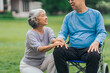 © M+Isolation+Photo - Asian people mature husband and wife, one in wheelchair, savoring peaceful outdoor moments in garden. Love and togetherness in midst of nature beauty. long live togetherness, valentine, insurance