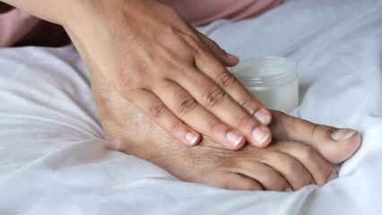 Wall Mural - woman using petroleum jelly on feet at home 