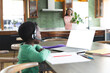 © WavebreakMediaMicro - African american boy having online class using headphones and laptop with copy space, slow motion