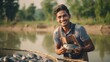 A farmer who raises fish in cages stands on a fish cage, he smiles happily with his work