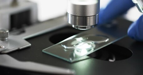 Poster - Video of close up of scientist using laboratory microscope with copy space on white background