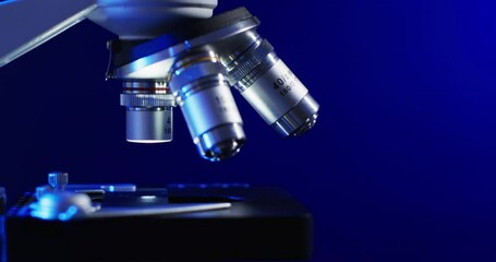 Poster - Video of close up of laboratory microscope with copy space on blue background