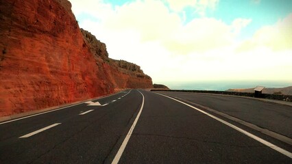 Wall Mural - Warm golden color sunset on the road for travel destination concept in scenic place. Wanderlust. Freedom and future. Sunlight and blue sky in background. Empty road and perspective movement journey.