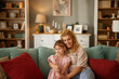© Stockphotodirectors - Cute little girl and her happy mother sitting at home