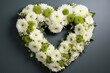 Heart shaped funeral wreath in white and green comprised of white chrysanthemums in flower market