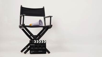 Wall Mural - Black director chair and black clapper board with yellow megaphone on white background