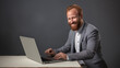© Alex - man with red beard at work in office with laptop and cash, in the style of dark gray and light gray, object portraiture specialist, uniformly staged images, danish design, non-representational