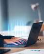 © Mumtaaz D/peopleimages.com - Laptop, hands and data hologram in office, coding software or ux programming for analysis, technology or analytics. Cybersecurity, ui design and digital career as marketing analyst, web or statistics