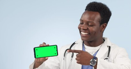 Wall Mural - Doctor, phone and happy man pointing to green screen in studio isolated on a blue background mockup space. Smartphone, tracking markers and hand of African medical professional advertising healthcare