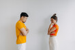 © Suthida - Asian Thai couple lover wear yellow and orange, standing and getting mad angry, sulking upset isolated on white background.