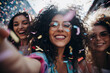 group of diverse woman surrounded by confetti celebrating and happy in daytime