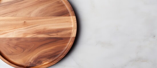 Poster - Top down view of an empty wooden pizza platter on a white stone kitchen table with copyspace for text