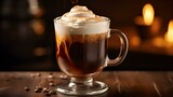 Close up an Irish Coffee in a Glass Mug topped with Cream. Blurred Kitchen Background