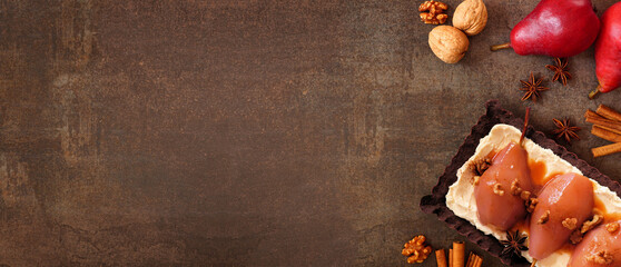 Poster - Spice poached pear tart. Above view side border table scene over a dark stone banner background. Copy space.