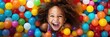 © Jim1786 - Banner laughing child girl having fun in ball pit on birthday party in kids amusement park and indoor play center, laughing, playing with colorful balls in playground ball pool.