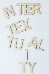 Sticker - inter•tex•tu•al•i•ty concept sign made with wood letters on blank paper