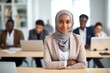 © Hope - Beautiful and cheerful Arabian student in hijab attending a class at university classroom. Education concept