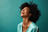 Fototapeta  - A joyful black woman with her mouth wide open in laughter, expressing pure happiness.