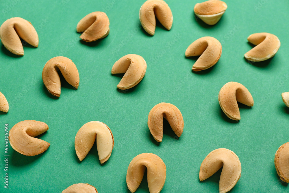 Fortune cookies scattered on green background
