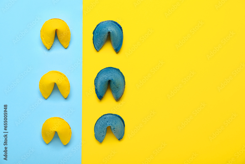 Composition with blue and yellow fortune cookies on color background