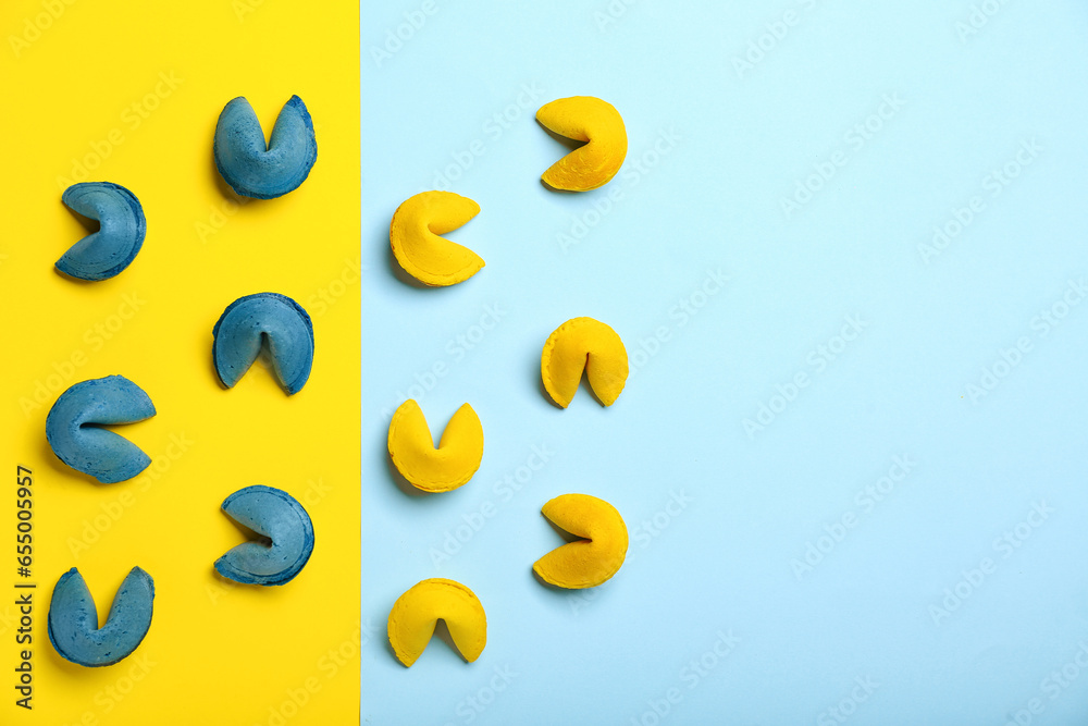Composition with blue and yellow fortune cookies on color background