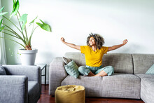 Happy Afro American Woman Relaxing On The Sofa At Home - Smiling Girl Enjoying Day Off Lying On The Couch - Healthy Life Style, Good Vibes People And New Home Concept