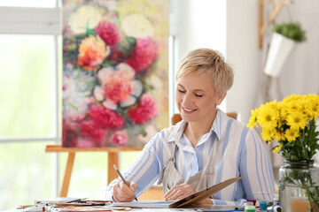 Poster - Mature female artist drawing sketch in  workshop