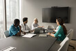 © fizkes - Senior chief doctor woman talking to diverse team of medical practitioners in boardroom. Clinic staff sitting at meeting table, discussing cooperation, brainstorming, teamwork