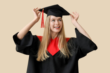 Canvas Print - Female graduate student on beige background