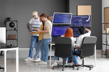 Poster - Team of young programmers working in office