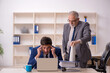 © Elnur - Old male boss and young male employee in the office