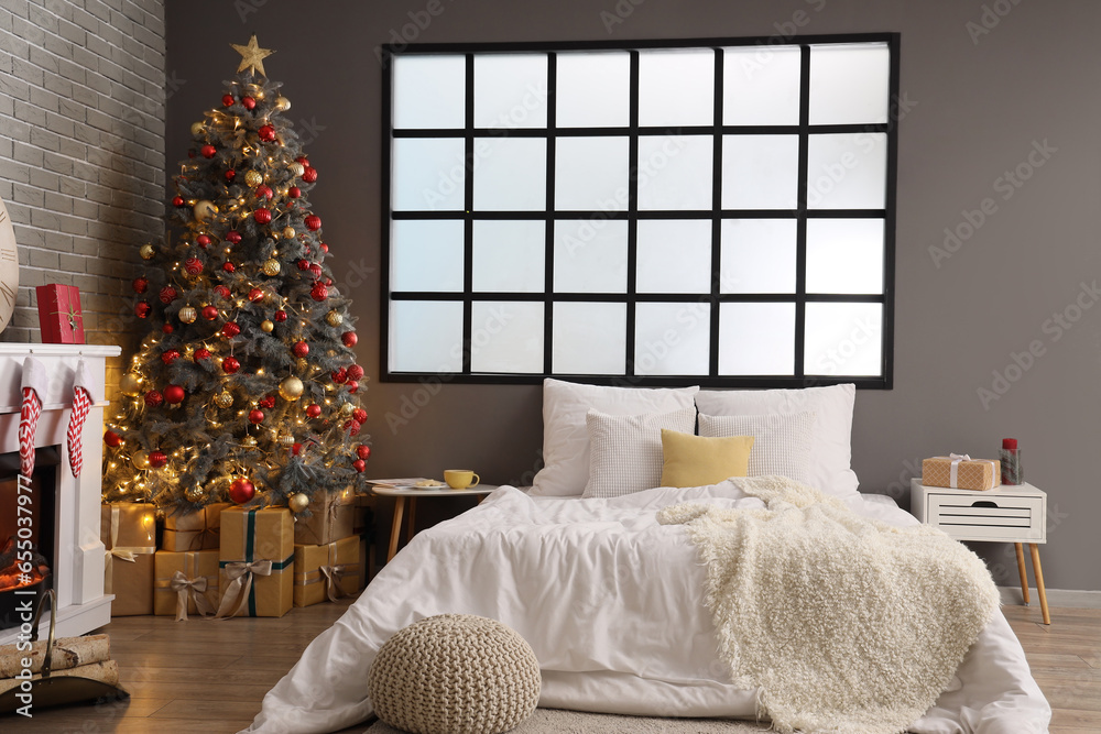 Interior of festive bedroom with Christmas tree