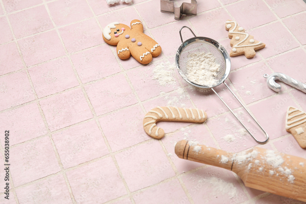 Composition with Christmas cookies, kitchen utensils and decorations on color tile background