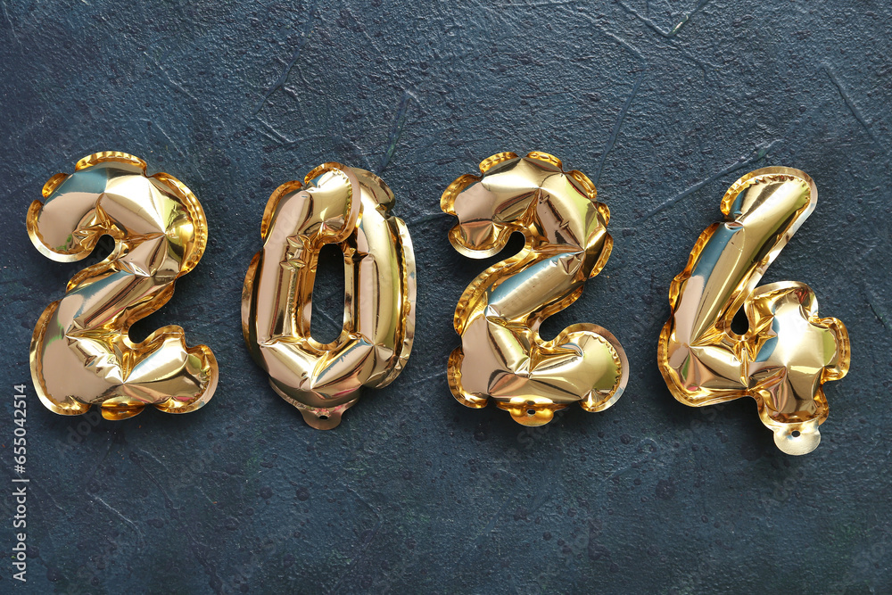 Figure 2024 made of foil balloons on black background