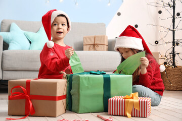 Sticker - Adorable little children opening Christmas gift at home