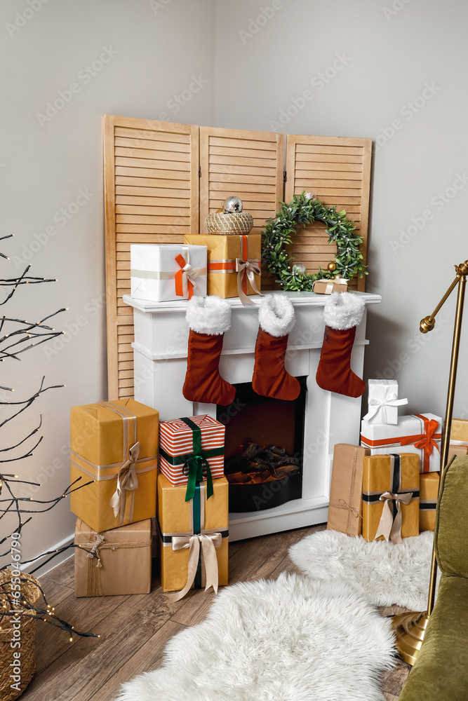 Fireplace with Christmas wreath and presents in living room