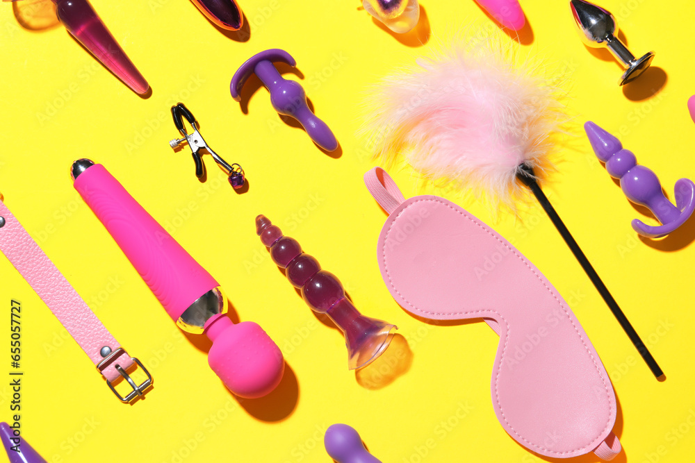 Different sex toys on yellow background