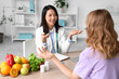 Female Asian nutritionist working with patient in office