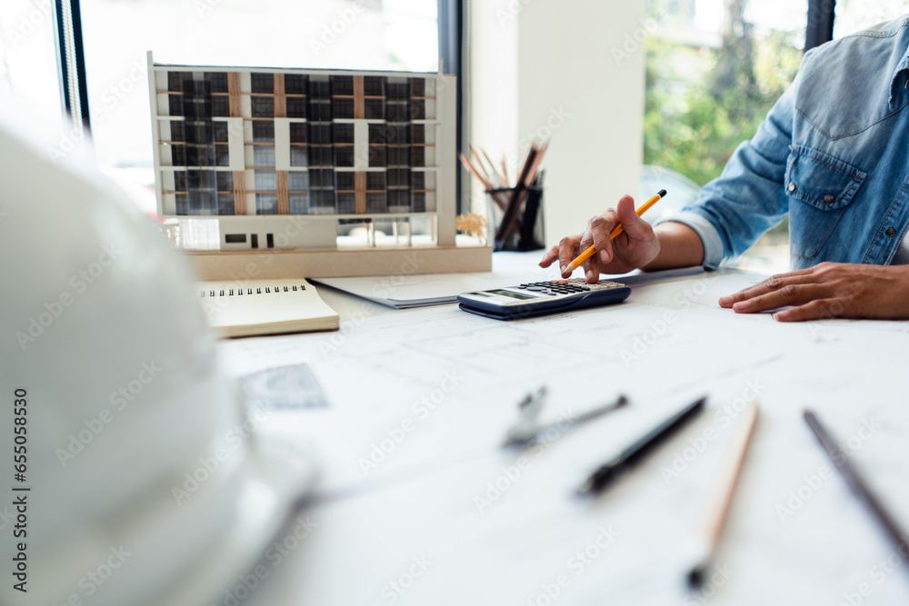 Engineer woman use scientific calculator and working to drawing ...