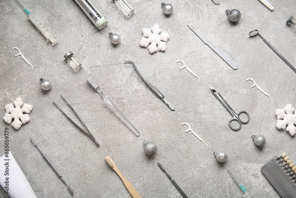 Dental tools with Christmas decor on grey background