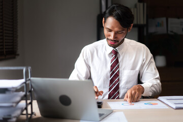 Wall Mural - Businessman using calculator to checking marketing graph document and analyzing strategy of startup