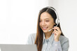 © M+Isolation+Photo - Asian people call center agent in serene work environment, expertly handling client issues via her laptop at organized workspace. representation of modern telecommunication pivotal role in business.