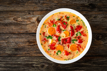 Wall Mural - Tomato soup with cream on wooden table
