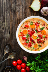 Wall Mural - Tomato soup with cream on wooden table
