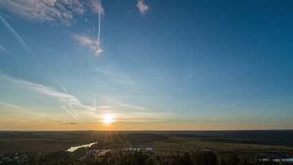 Wall Mural - Sunset timelapse above the valley, view from the mountain. Blue sky with moving clouds. Beautiful landscape, 4k