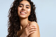 Happy young woman with natural beauty, and beautiful curly hair with cream on cheek