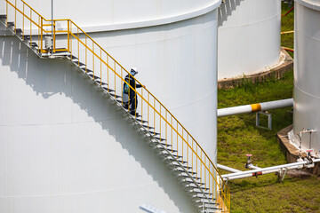 Wall Mural - A male walking the upstairs inspection visual record storage tank oil stairs on the side