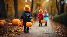 Little Children Doing Tricks With Pumpkin Bags During Halloween